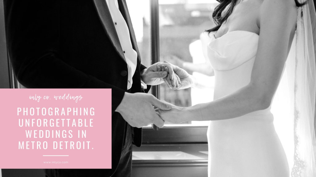 black and white image of bride and groom holding hands, cropped at shoulders and hips, with an overlayed inly-pink box and white words "inly co. weddings. photographing unforgettable weddings in metro Detroit inlyco.com"